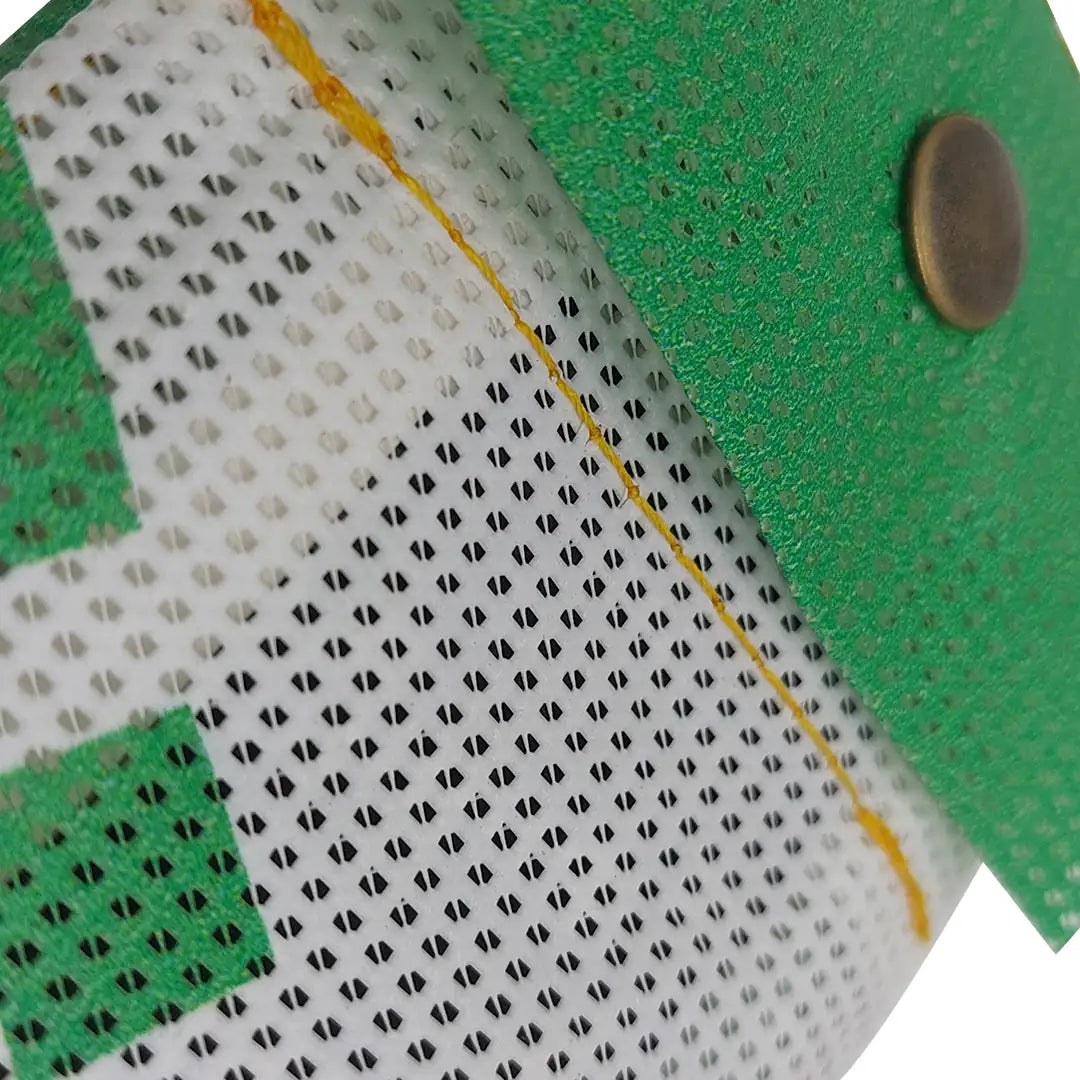 Compact pouch made from reclaimed micro-perforated banner, with snap closure and a green-and-white graphic surface. - detail
