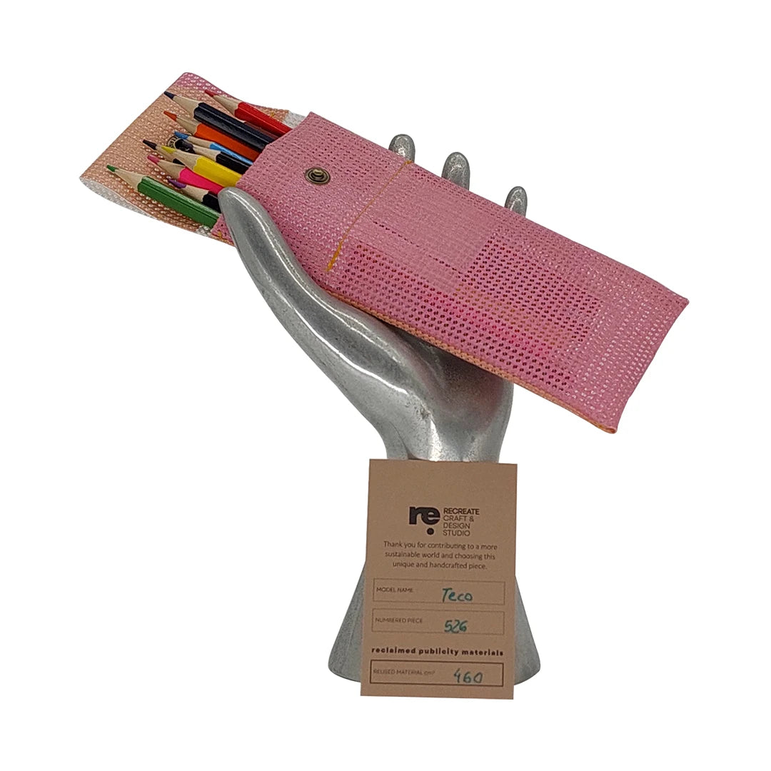 Soft pink pouch made from reclaimed micro-perforated material, designed for pencils, pens and small everyday objects. - on hand