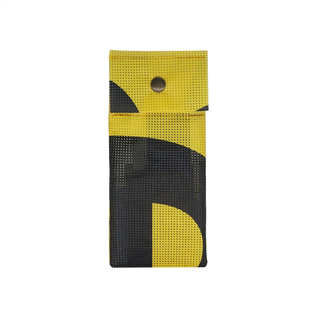 Yellow and black pouch made from reclaimed micro-perforated banner, designed to hold pencils, pens or slim everyday tools in a compact format. - front