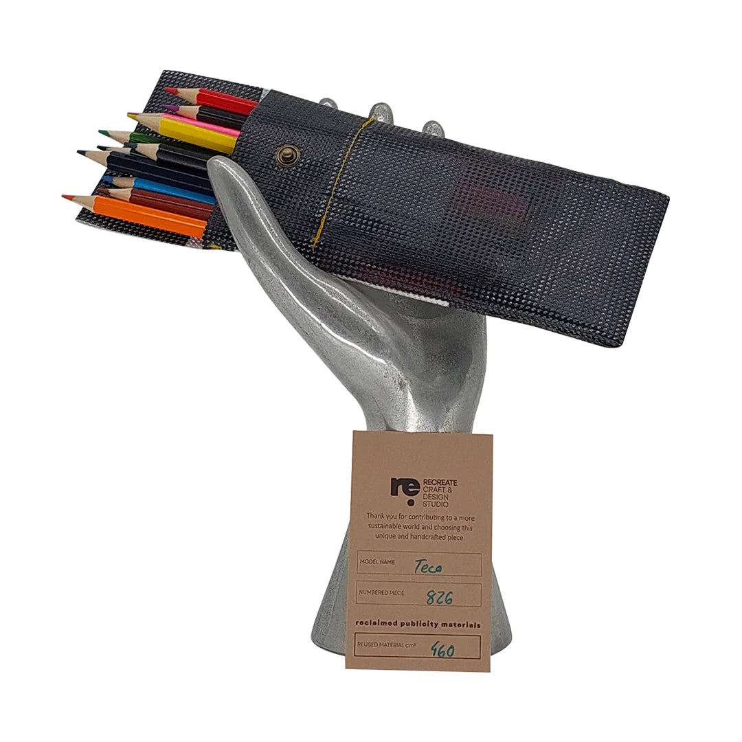 Teco Pouch 826 by ReCreate is a slim pouch made from reclaimed micro-perforated banner, ideal for pencils, pens and other everyday essentials. - with pencils