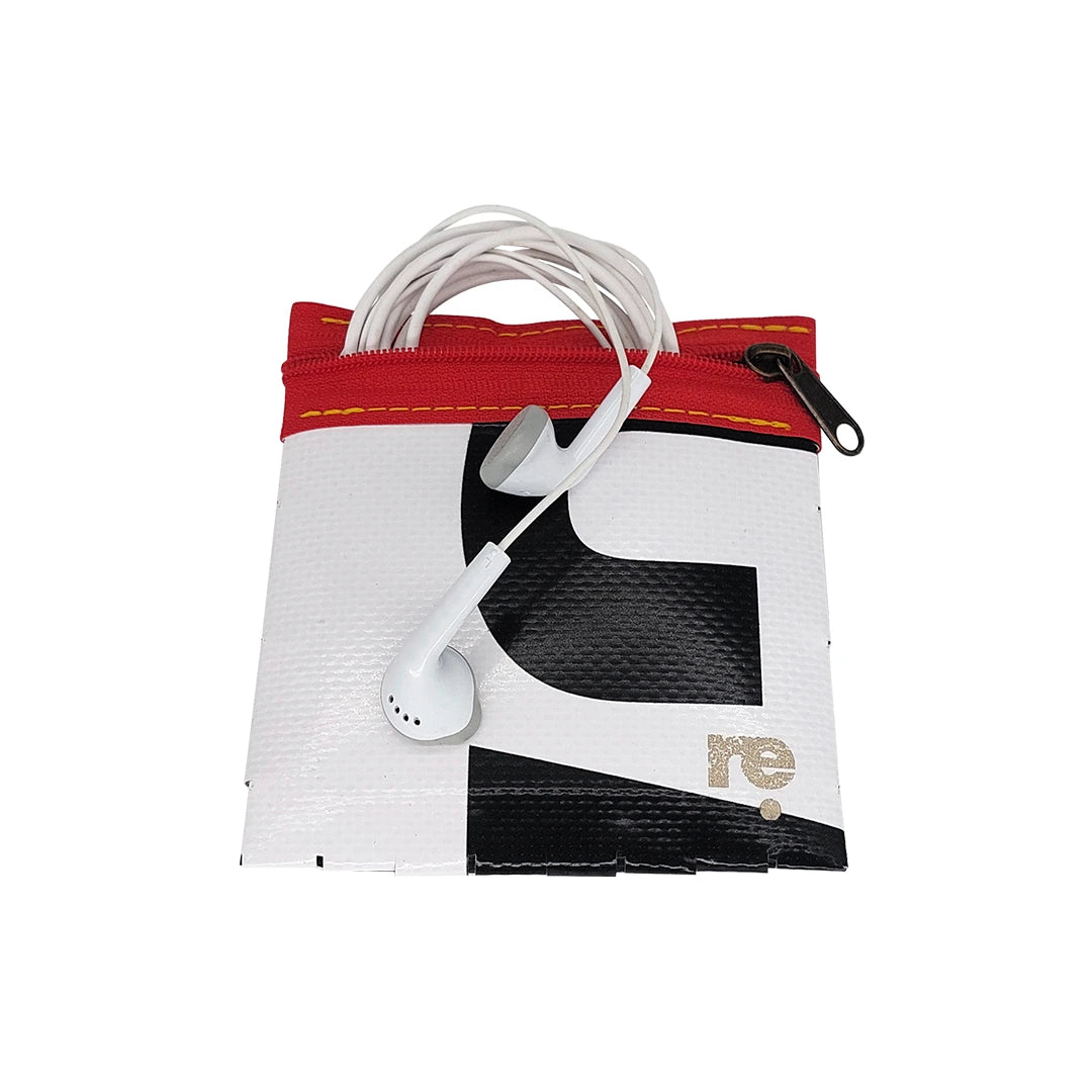 Tom Pouch 1625 is a ReCreate pouch made from reclaimed advertising banner, with black and white graphic shapes, red zip and woven back. - with phones