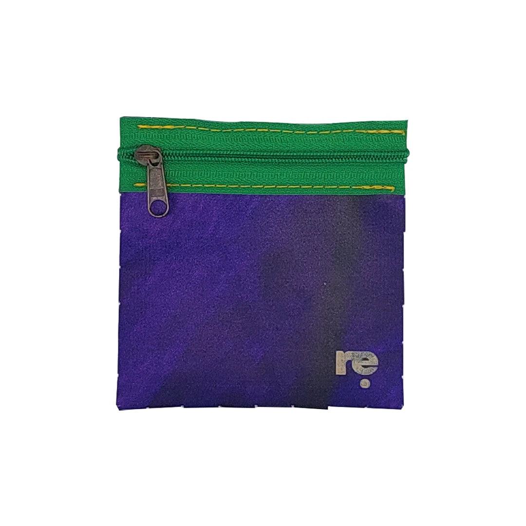 Tom Pouch 226 is a ReCreate pouch made from reclaimed advertising banner, with deep violet tones, green zip and woven back. - front