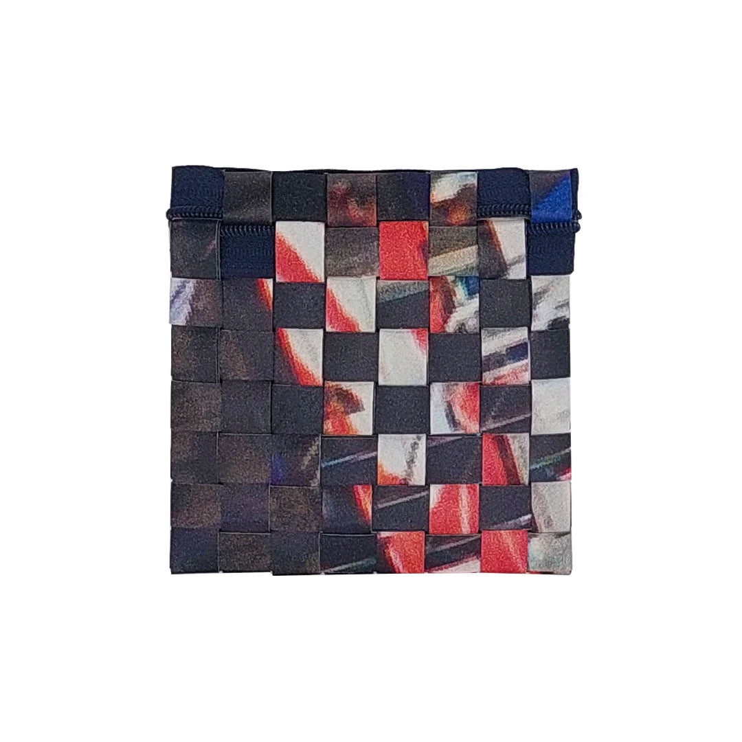 Tom Pouch 426 is a ReCreate pouch made from reclaimed advertising banner, with dark photographic tones, red flashes and woven detail. - back