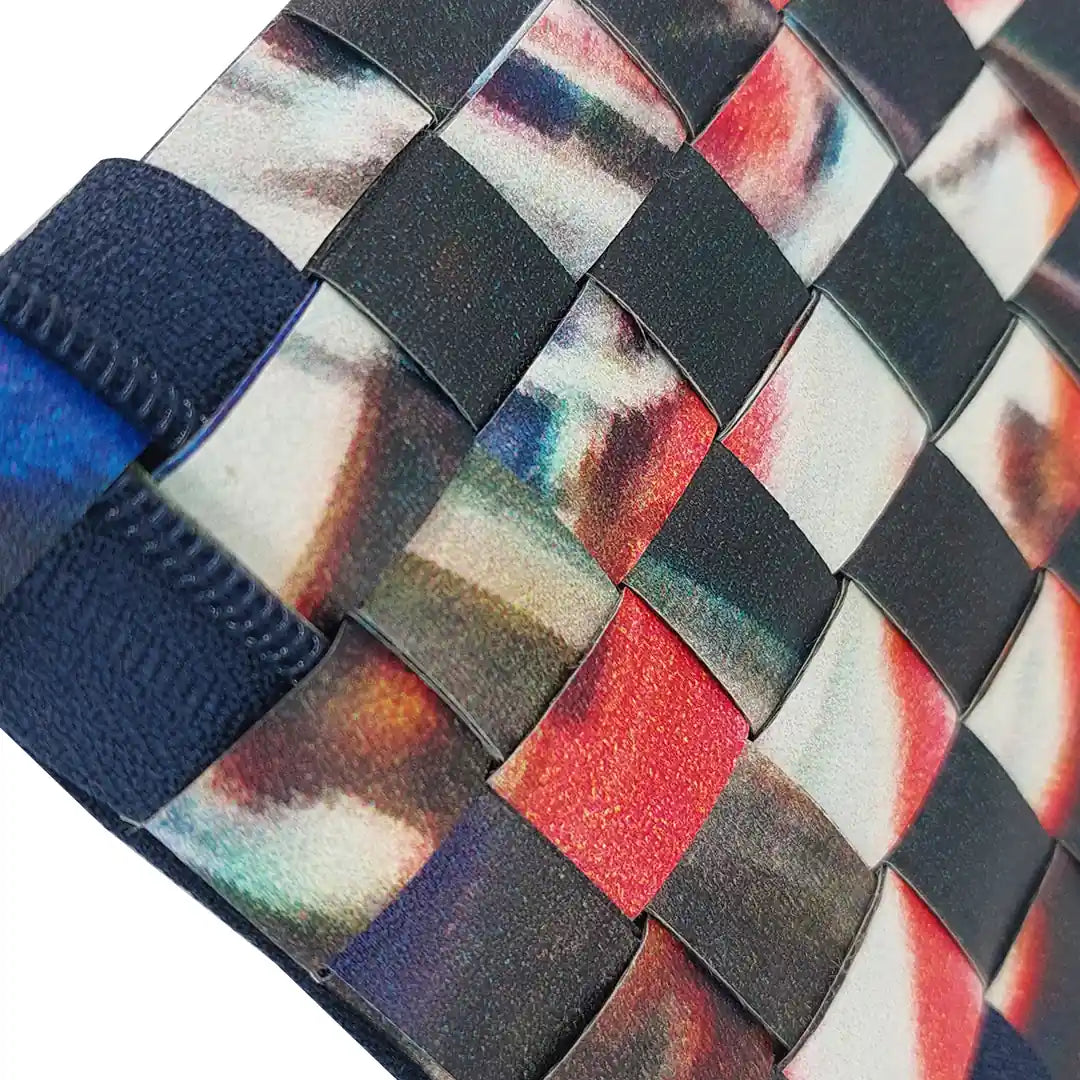 Tom Pouch 426 is a ReCreate pouch made from reclaimed advertising banner, with dark photographic tones, red flashes and woven detail. -detail